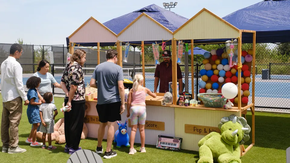 Families enjoying colourful outdoor carnival games